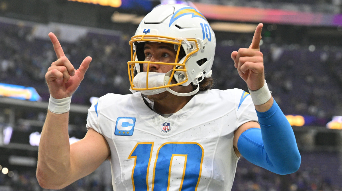 Chargers quarterback Justin Herberts points to the crowd after a win